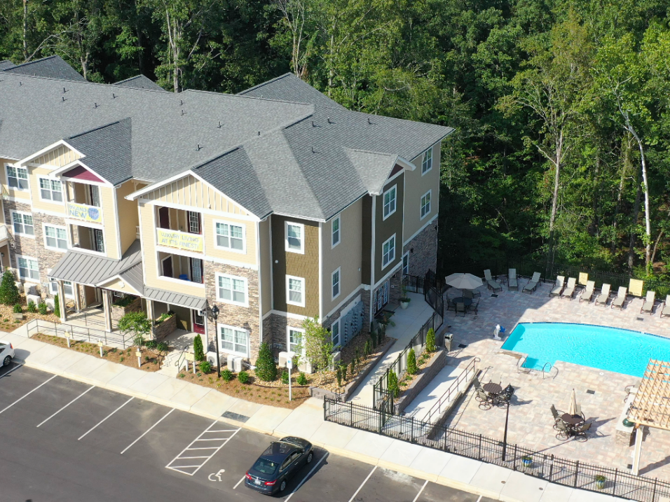 aerial view of apartment building with pool