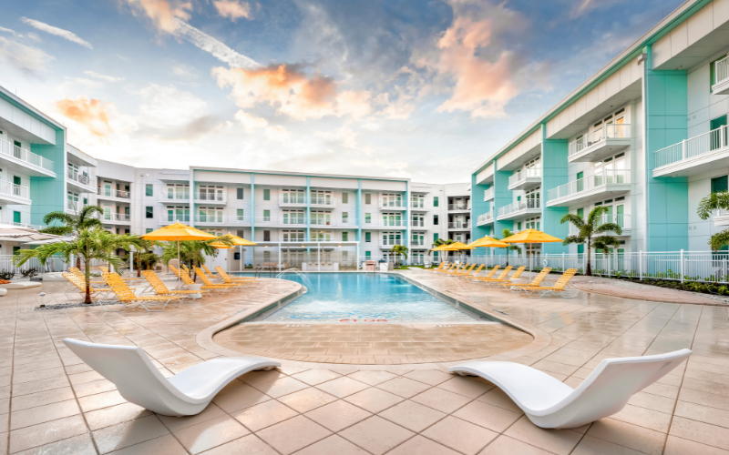 apartment community pool and courtyard at sunset